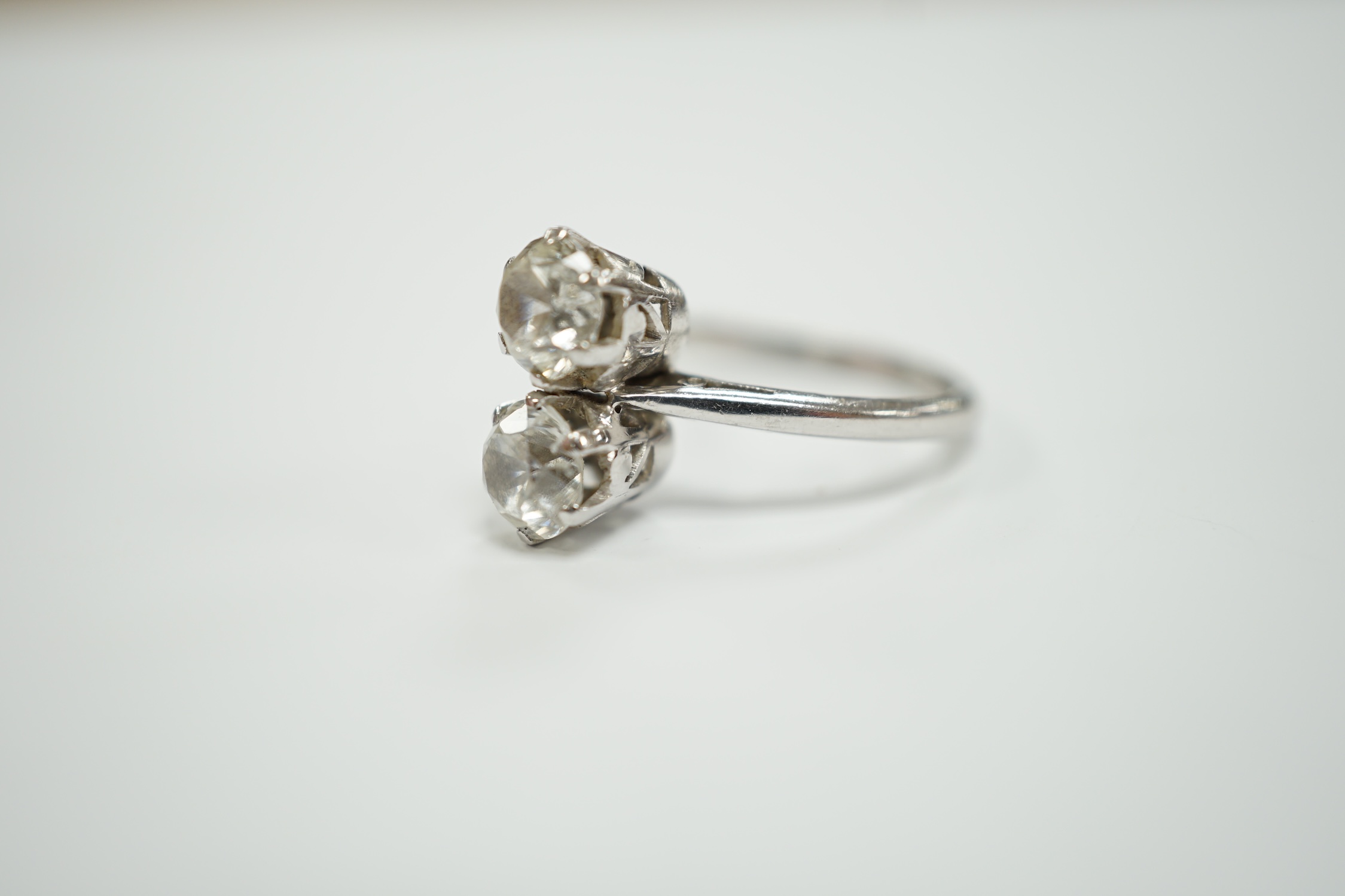 A mid 20th century white metal (stamped plat) and two stone white zircon? set ring, size M, gross weight 4.9 grams.